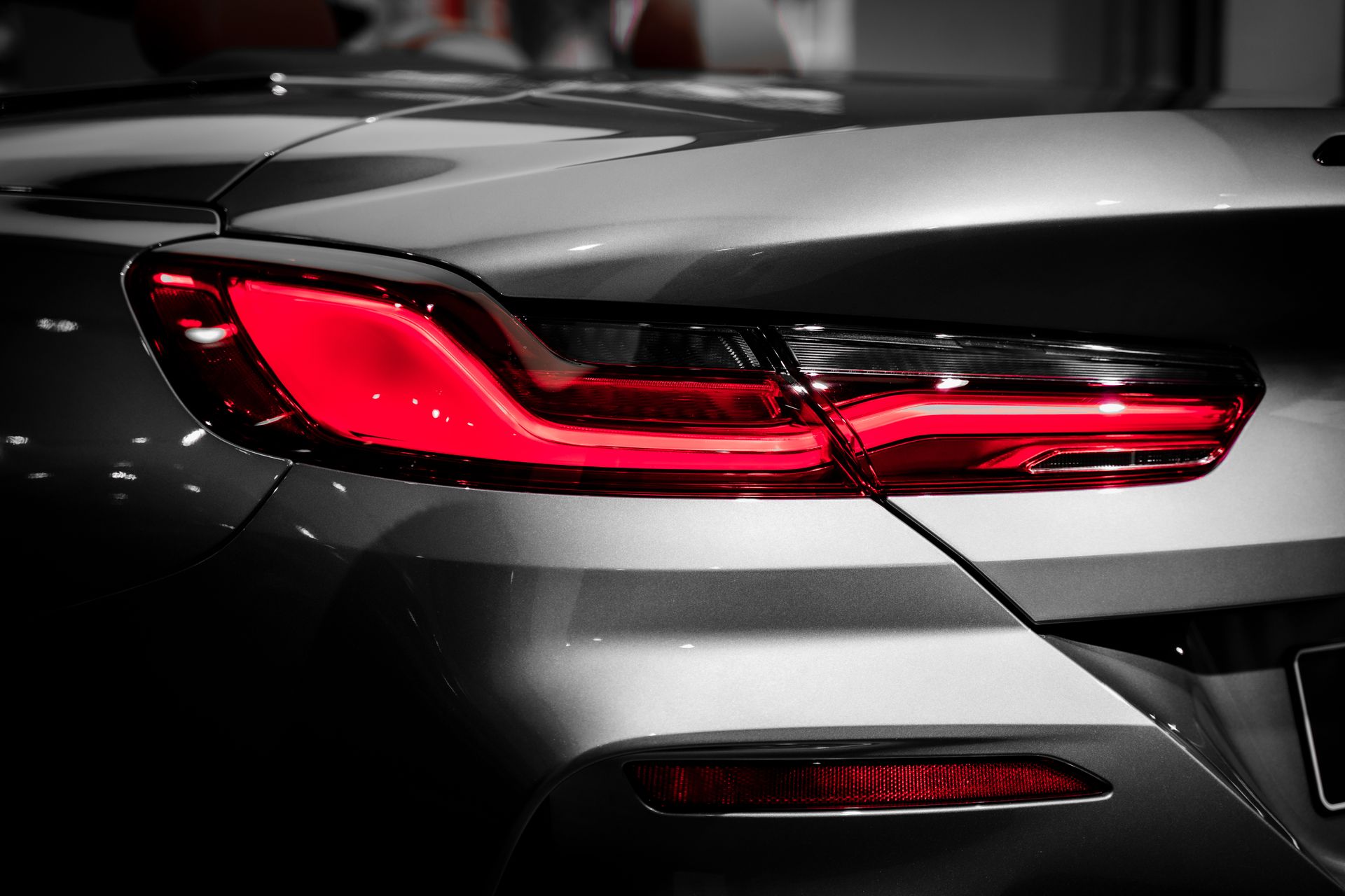 Polished rear quarter panel and glowing taillight on a detailed sports coupe